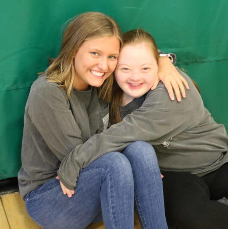 Evie and Joy smiling for a picture.