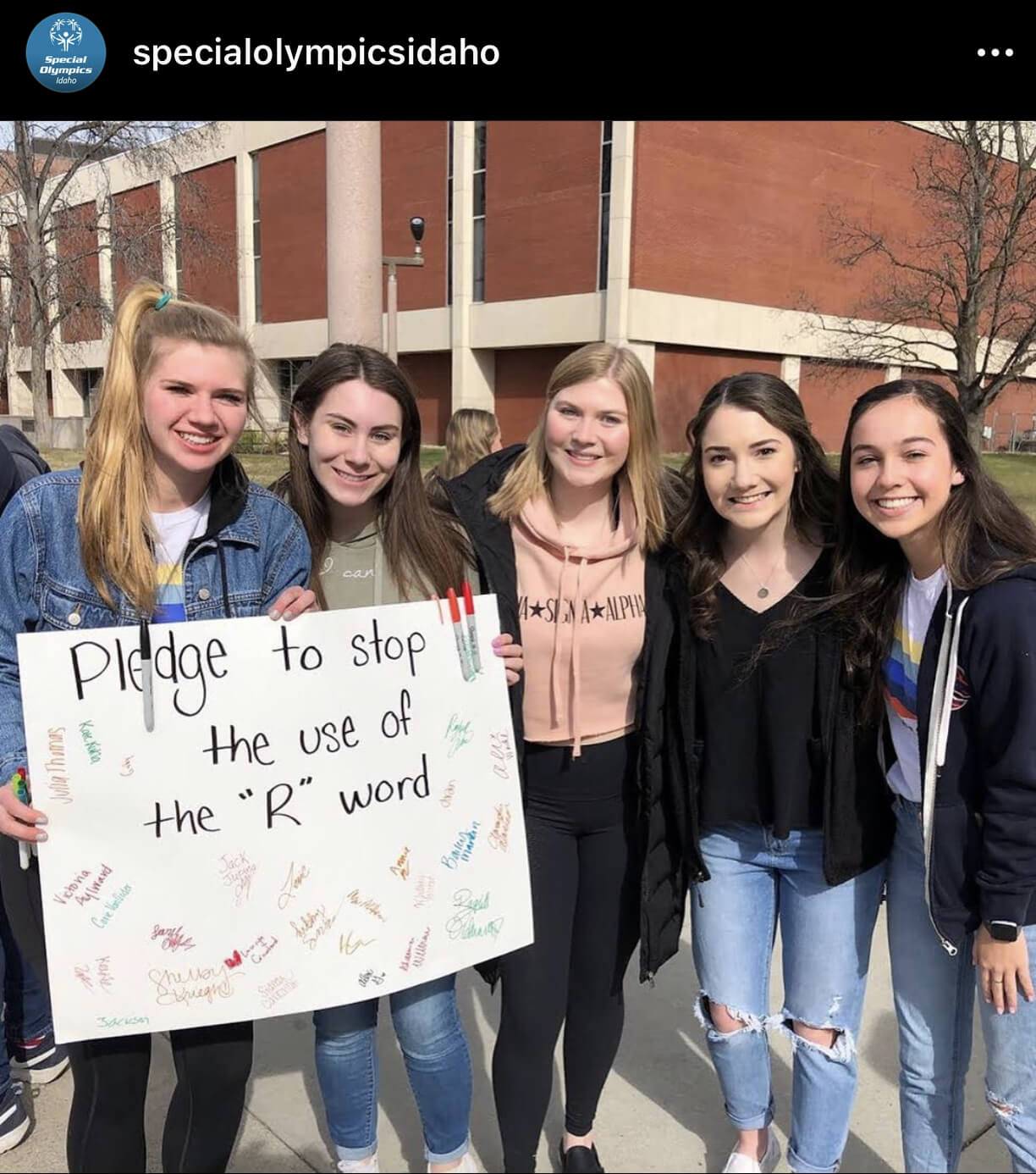 Group of Boise State University students posing with their spread the word poster.