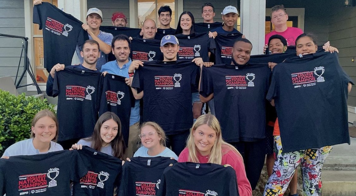 Students holding Champion Shirts