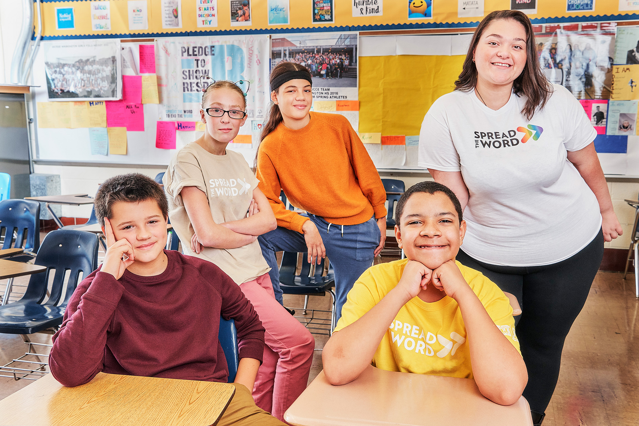 Students Smiling at the camera wearing Spread the Word Shirts